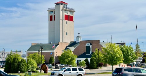 The Door County Maritime Museum exterior with cars in the foreground in a parking lot
