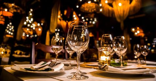 fine dining table with wine glasses and table settings