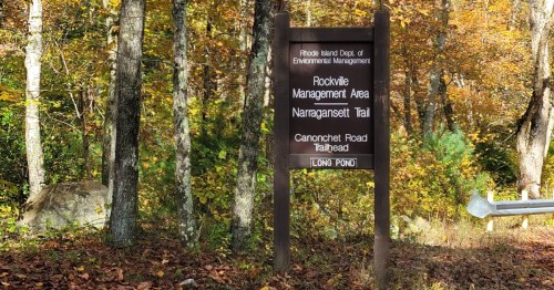 Brown trailhead sign for Rockville Management Area Narragansett Trail at Canonchet Road.