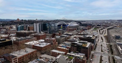 Looking out from a vacation rental's balcony toward downtown Seattle, including Lumen Field.