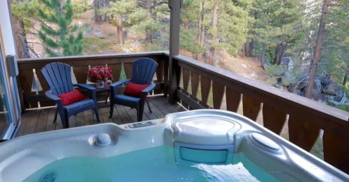 Looking down at a hot tub on a wooden deck overlooking a forest in Incline Village, Nevada.