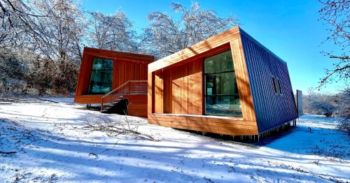 Modern, minimalist style cedar cabins in the snow
