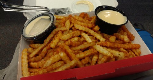 an open red box reveals chickie's and pete's world famous crab fries at the philadelphia international airport