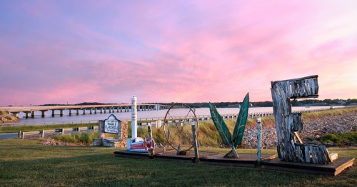 A sign made out of recycled materials that spells out love in front of the entrance to Clarksville, Virginia.