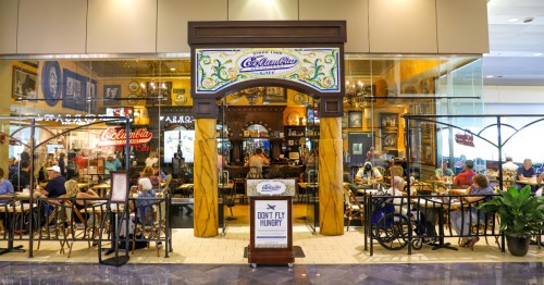 exterior of Columbia Café at Tampa International Airport with customers at tables