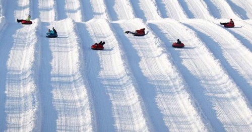 several snow tubers tube down snow tubing runs at flagstaff snow park in arizona