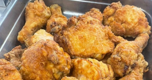 A tray of crispy, deep-fried chicken pieces with a perfectly golden, textured breading.