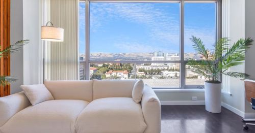 A living room with large windows.