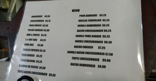 A laminated piece of paper with a simple menu on it.