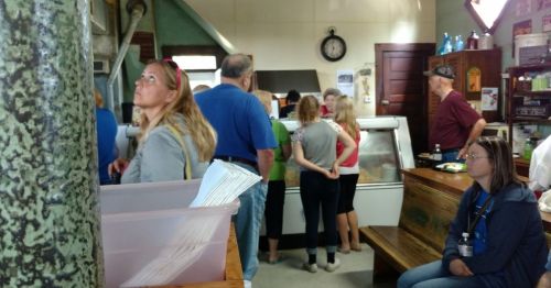 People waiting in line at a burger joint.