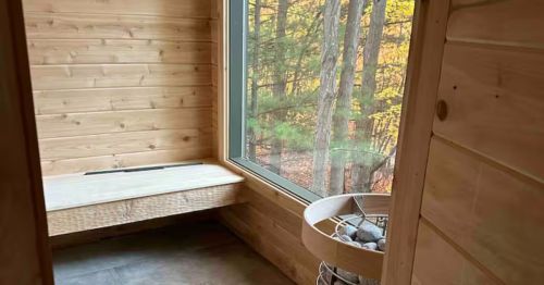 The entry of a sauna with a large window.