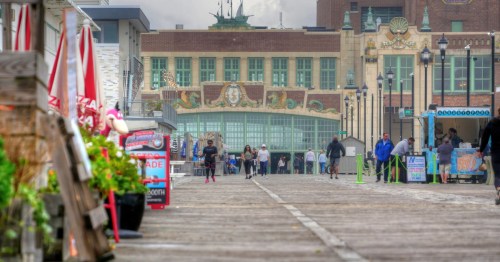 The facade of the Asbury Park Convention Hall, a historic art-deco building set against the town's boardwalk.
