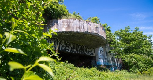 A massive, earth-covered World War II bunker now filled with murals and graffiti art.