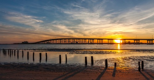 Sunset behind a bridge over the Gulf coast in Biloxi, Mississippi