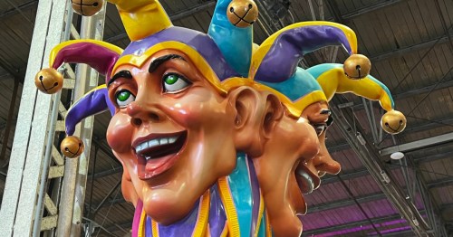 A larger-than-life two-faced harlequin Mardi Gras float