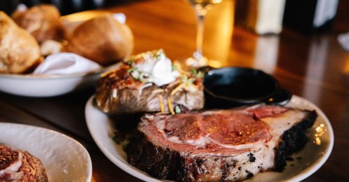 Prime rib served with a baked potato, roll, and glass of wine at Gary's Supper Club in the Twin Cities.