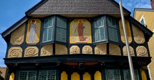 Intricate murals and half-timbered details on the facade of Fleur-de-Lys Studio in Providence, Rhode Island.