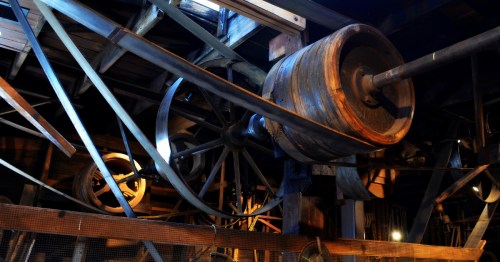 Historic wooden pulleys and belt-driven machinery inside the Kregel Windmill Factory Museum in Nebraska City.