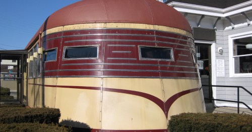 Close-up of the curved, burgundy and cream steel exterior of the historic Modern Diner in Pawtucket, Rhode Island.