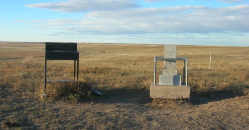 Stone marker and metal desk at Panorama Point, Nebraska, under a blue sky on the flat high plains.