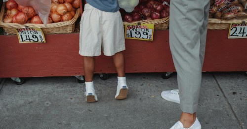 A family shopping for fresh produce at a local outdoor farmers market in Maryland.