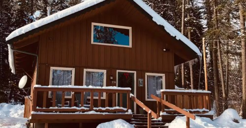 The exterior of a Swiss-style chalet covered in snow in northern Idaho.