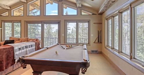 A pool table in a living room space in a home in Lead, South Dakota, that looks like North Tyrol.