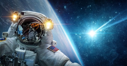 An American astronaut takes a spacewalk with Earth in the background.