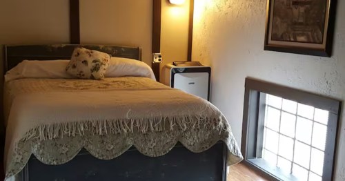 Cozy bedroom at this Italian Airbnb North Dakota, featuring rustic charm and soft natural light.