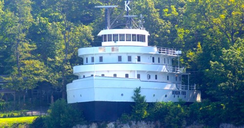 The unique Benson Ford Shiphouse in Put-in-Bay, Ohio, features the pilot house and forward deck of a former shipping vessel perched atop a cliff overlooking Lake Erie.