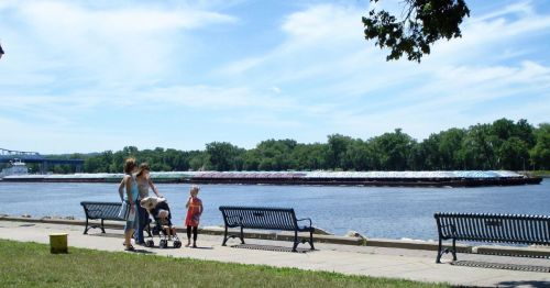 Children and moms walking next to a river in La Crosse, Wisconsin