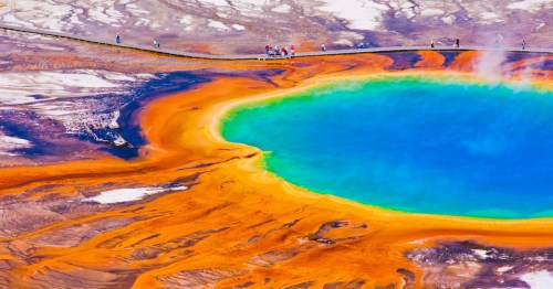 Vibrant blue and orange waters shimmer at Grand Prismatic Spring in Yellowstone National Park.