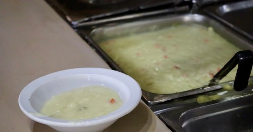 A bowl and buffet tray of creamy potato all you can eat soup Michigan at a family dining restaurant.