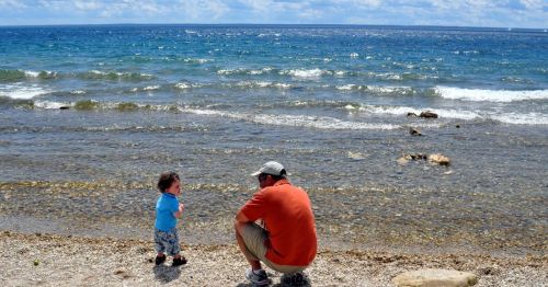 A parent and child at a beach in Michigan.