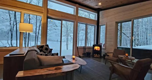The living room with fireplace at the Hayward Haus in Hayward, Wisconsin which looks like a dupe of a cabin in Scandinavia