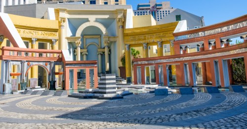 the colorful facade of a building behind the piazza d'italia. in new orleans