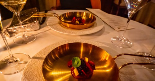 copper dishes with a dessert on top of a table with wine glasses and tablecloth at the reserve in scottsdale az