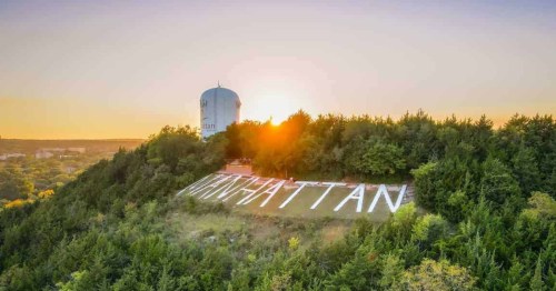 Sunset view of the Manhattan hill sign and water tower in Manhattan, Kansas.