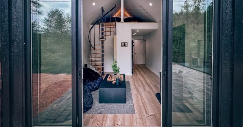 a look inside a scandinavian style home with a spiral staircase