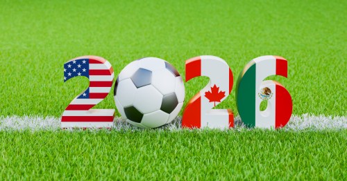 signage for 2026 featuring the american, canadian, and mexican flags and a soccer ball on a soccer field