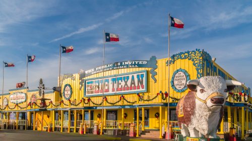 The Big Texan Steak Ranch & Brewery is a bright yellow attraction along iconic Route 66.