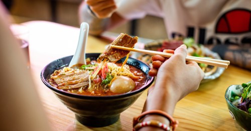 A woman eats healthy Japanese food, ramen, sushi, and soup.