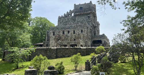 Wide view of the stone Gillette Castle and surrounding grounds in East Haddam, Connecticut.