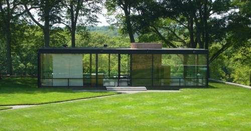 The minimalist Glass House in New Canaan, Connecticut, featuring floor-to-ceiling glass walls and a central brick core.