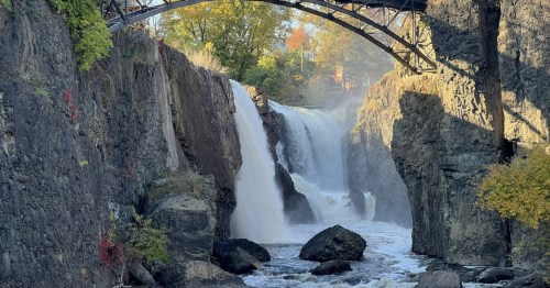 A close-up shot of the Paterson Great Falls, surrounded by fall foliage.