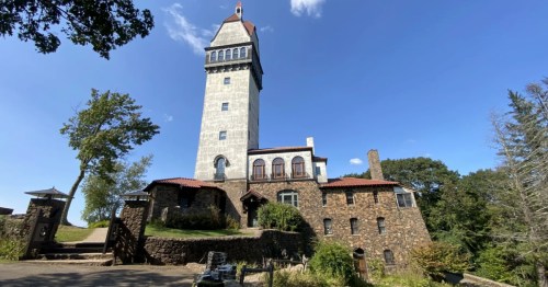 The tall, white Heublein Tower atop a stone base at Talcott Mountain State Park in Avon, Connecticut.
