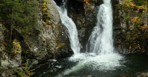 An autumn view of the cascading Bash Bish Falls waterfall in Mount Washington, Massachusetts.