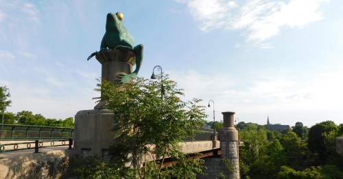 Concrete bullfrog perched on a spool of thread at the Thread City Crossing "Frog Bridge" in Willimantic, Connecticut.