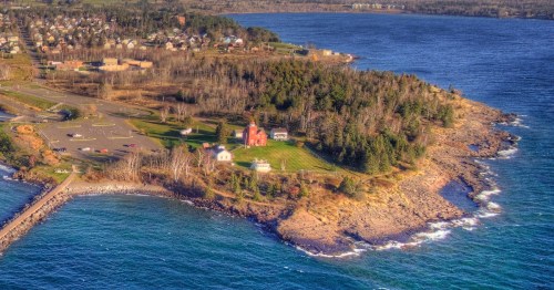 Aerial view of Two Harbors Lighthouse and the rocky shoreline of Burlington Bay, Minnesota.