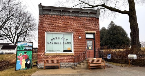 The historic red brick Burr Oak Savings Bank building serves as the Laura Ingalls Wilder Visitor Center in Iowa.